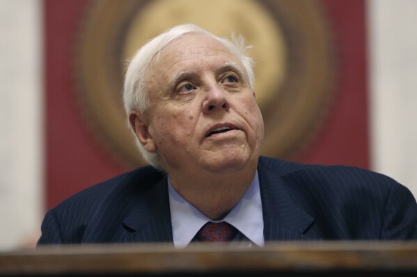 FILE - West Virginia Gov. Jim Justice delivers his State of the State address, Jan. 10, 2024, in Charleston, W.Va. Justice on Wednesday, March 27, broke with the GOP-majority Legislature to veto a bill that would have loosened one of the country's strictest school vaccination policies. (AP Photo/Chris Jackson, File)