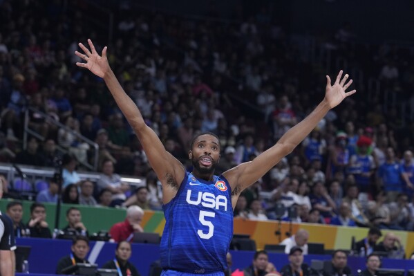CORRECTS DATE TO TUESDAY, SEPT. 5, 2023 U.S. forward Mikal Bridges (5) gestures during the Basketball World Cup quarterfinal game between Italy and U.S. at the Mall of Asia Arena in Manila, Philippines, Tuesday, Sept. 5, 2023. (AP Photo/Michael Conroy)