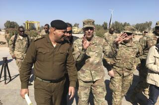 FILE - In this Feb. 8, 2017, file photo, then-Army Lt. Gen. Stephen Townsend talks with an Iraqi officer during a tour north of Baghdad, Iraq. Townsen, now a general, says a growing military threat from China may well come from America’s east, as Beijing looks to establish a large navy port capable of hosting submarines or aircraft carriers on the Atlantic coast of Africa.(AP Photo/ Ali Abdul Hassan, File)