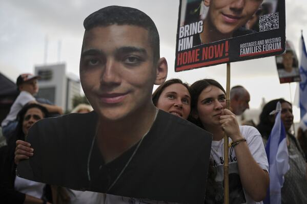 People watch a live broadcast of Israeli-American soldier Edan Alexander as he is released from Hamas captivity in Gaza, at a plaza known as the hostages square in Tel Aviv, Monday, May 12, 2025. Alexander was abducted during the Hamas-led attack on his base on October 7, 2023. (AP Photo/Oded Balilty)