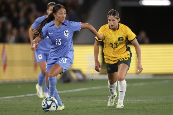France's Selma Bacha, left, and Australia's Kyra Cooney-Cross compete for the ball during their friendly soccer match in Melbourne, Friday, July 14, 2023, ahead of the Women's World Cup. (AP Photo/Hamish Blair)