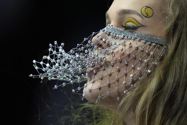 A cheerleaders team member wearing a pseudo anti-coronavirus face mask performs during the St. Petersburg Open ATP tennis tournament match in St. Petersburg, Russia, Wednesday, Oct. 27, 2021. (AP Photo/Dmitry Lovetsky)
