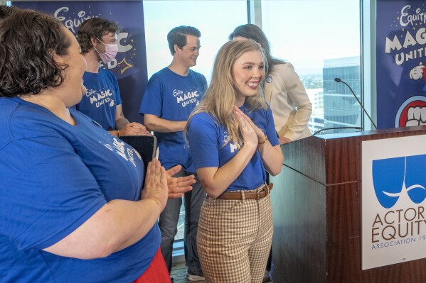 Actors Angela Nichols, far left, and Courtney Griffith, center, and workers who help bring Disneyland's beloved characters to life as they announce they've collected enough signatures to support their push for a union during a news conference in Anaheim, Calif., Wednesday, April 17, 2024. Workers who help bring Disneyland's beloved characters to life said Wednesday they collected enough signatures to support their push for a union. (AP Photo/Damian Dovarganes)