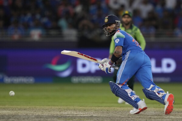 India's Virat Kohli plays a shot during the ICC Champions Trophy cricket match between India and Pakistan at Dubai International Cricket Stadium, United Arab Emirates, Sunday, Feb. 23, 2025. (AP Photo/Altaf Qadri)