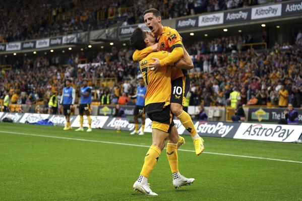 Wolverhampton Wanderers' Daniel Podence, right, celebrates with his teammate Neto scoring his side's first goal during the English Premier League soccer match between Wolverhampton Wanderers and Southampton, at Molineux Stadium, Wolverhampton, England, Saturday Sept. 3, 2022. (Tim Goode/PA via AP)