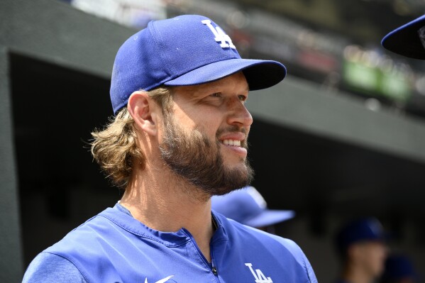 Los Angeles Dodgers' Clayton Kershaw stands in the dugout during the first inning of a baseball game against the Baltimore Orioles, Wednesday, July 19, 2023, in Baltimore. (AP Photo/Nick Wass)