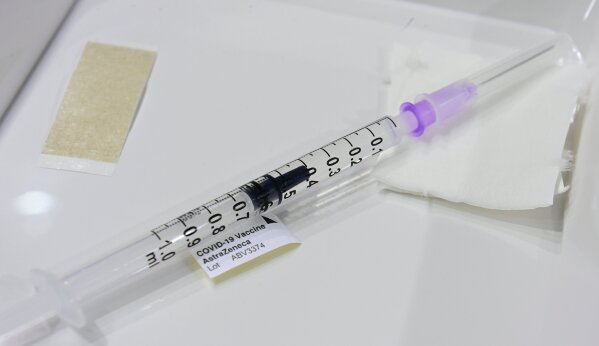 FILE - In this March 8, 2021 file photo, a syringe with the AstraZeneca vaccine is picutred at a new vaccination centre at the former Tempelhof airport in Berlin, Germany. AstraZeneca’s release of encouraging data about its coronavirus vaccine from its U.S. trial raised hopes that the drug company could bury doubts about the shot and put a troubled rollout behind it. But just hours later, U.S. officials released an unusual statement expressing concerns AstraZeneca had included “outdated information” from its study and that it may have provided “an incomplete view of the efficacy data.” (Tobias Schwarz/Pool Photo via AP, File)