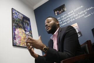 FILE -- In this Wednesday Aug. 14, 2019 file photo Stockton Mayor Michael Tubbs discusses a program he initiated to give $500 to 125 people who earn at or below the city's median household income of $46,033 during an interview in Stockton, Calif. After eight months new data shows people have spent 70 percent of that money on things like food, clothing and utility bills. Tubbs hopes the new data will win over skeptics. (AP Photo/Rich Pedroncelli, File)