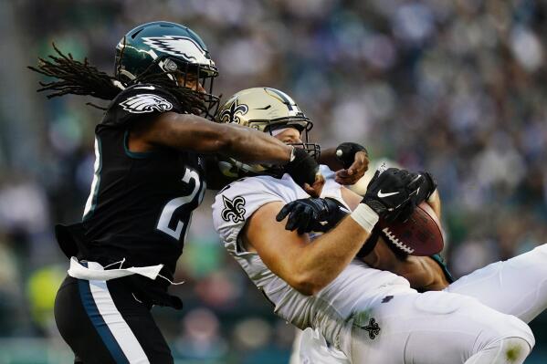 New Orleans Saints' Adam Trautman, right, pulls in a pass against Philadelphia Eagles' Anthony Harris during the second half of an NFL football game, Sunday, Nov. 21, 2021, in Philadelphia. (AP Photo/Derik Hamilton)