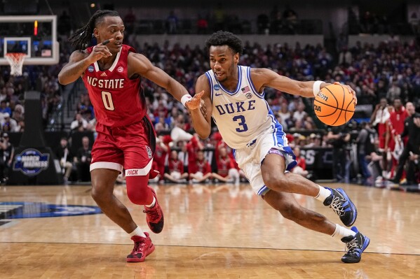 Duke's Jeremy Roach (3) drives against North Carolina State's DJ Horne (0) during the second half of an Elite Eight college basketball game in the NCAA Tournament in Dallas, Sunday, March 31, 2024. (AP Photo/Tony Gutierrez)