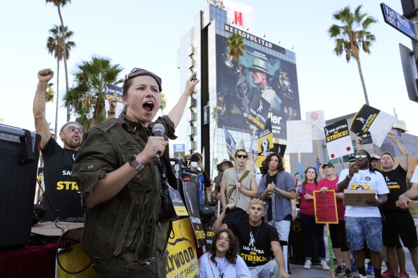 SAG-AFTRA captain Mary M. Flynn rallies fellow striking actors on a picket line outside Netflix studios, Wednesday, Nov. 8, 2023, in Los Angeles. (AP Photo/Chris Pizzello)