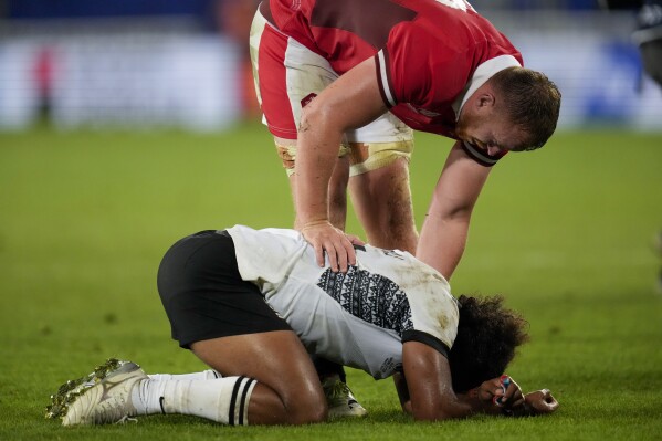Wales' Tommy Reffel, above, comforts Fiji's Simione Kuruvoli at the end of the Rugby World Cup Pool C match between Wales and Fiji at the Stade de Bordeaux in Bordeaux, France, Sunday, Sept. 10, 2023. (AP Photo/Themba Hadebe)