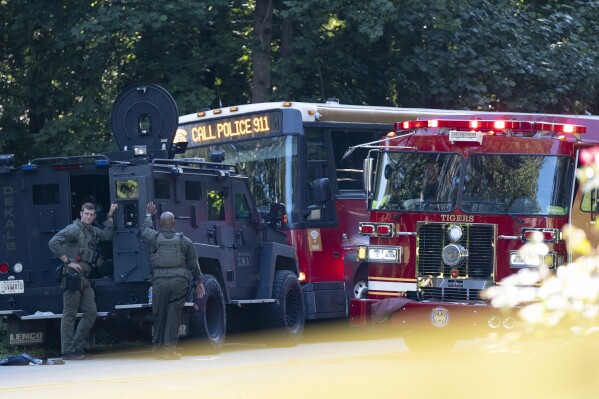 A Gwinnett County, Ga. commuter bus sits in the road where it was stopped in Smoke Rise, Ga., on Tuesday, June 11, 2024. Atlanta police say the transit bus fled from officers responding to a dispute on board, leading them on a wild and lengthty chase into a neighboring county before it was stopped. (AP Photo/Ben Gray)