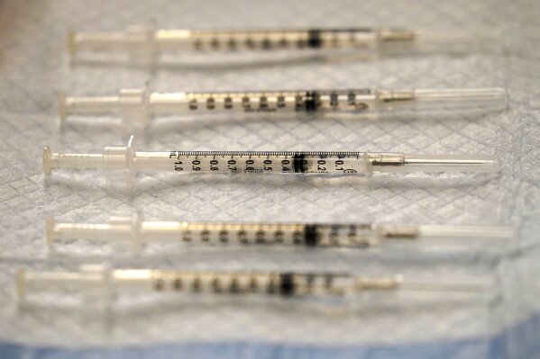 FILE - In this Dec. 17, 2020 file photo, prepared COVID-19 Pfizer-BioNTech vaccine syringes are seen at Edward Hospital in Naperville, Ill. The U.S. government is negotiating with Pfizer to acquire tens millions of additional vaccine doses in exchange for helping the pharmaceutical giant gain better access to manufacturing supplies. (AP Photo/Nam Y. Huh, File)