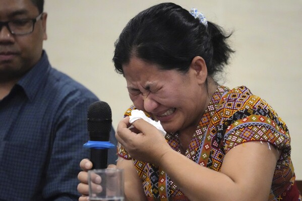 Burmese Zing Raltu breaks into tears as she talks to reporters after filing a criminal complaint against Myanmar's top generals at the Department of Justice in Manila, Philippines on Wednesday Oct. 25, 2023. Relatives of victims of alleged war crimes committed by Myanmar’s military filed a criminal complaint in the Philippines against their nation’s ruling generals in a desperate attempt to test whether such a case could succeed outside the violence-wracked country.(AP Photo/Aaron Favila)