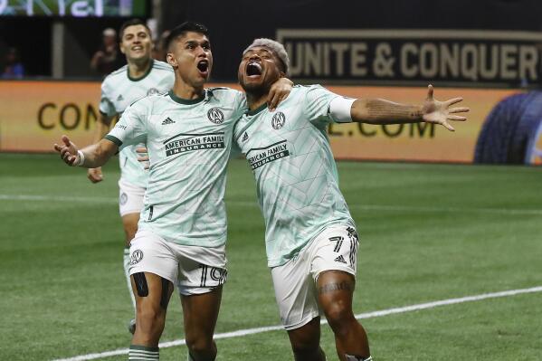 Atlanta United attacker Luiz De Araujo, left, celebrates his goal with an assist from attacker Josef Martinez, right, to take a lead over Inter Miami in an MLS soccer match Sunday, June 19, 2022, in Atlanta. (Curtis Compton/Atlanta Journal-Constitution via AP)