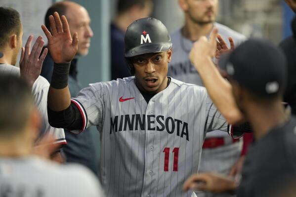 Minnesota Twins' Jorge Polanco (11) celebrates in the dugout after scoring off of a single by Kyle Farmer during the second inning of a baseball game against the Los Angeles Dodgers in Los Angeles, Monday, May 15, 2023. (AP Photo/Ashley Landis)