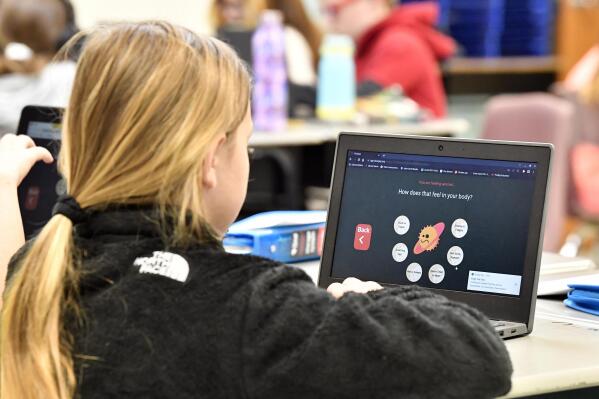 A student at Lakewood Elementary School in Cecilia, Ky., uses her laptop to participate in an emotional check-in at the start of the school day, Thursday, Aug. 11, 2022. The rural Kentucky school is one of thousands across the country using the technology to screen students' state of mind and alert teachers to anyone struggling. (AP Photo/Timothy D. Easley)