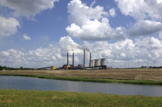 FILE - This June 3, 2014, file photo shows a panoramic view of the Paradise Fossil Plant in Drakesboro Ky. President Donald Trump's vow to save the coal industry will be tested this week when a utility board he appoints weighs whether to close a coal-fired power plant in Kentucky whose suppliers include a mine owned by one of his campaign donors. An environmental assessment by the Tennessee Valley Authority recommends shuttering the remaining coal-fired unit at the Paradise Fossil Plant in Muhlenberg County. The board could vote on Thursday, Feb. 14, 2019. (AP Photo/Dylan Lovan, File)