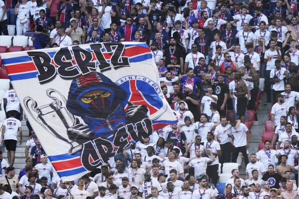 PSG fans wave flags on the stands ahead of the Champions League final soccer match between Paris Saint-Germain and Inter Milan at the Allianz Arena in Munich, Germany, Saturday, May 31, 2025. (AP Photo/Luca Bruno)