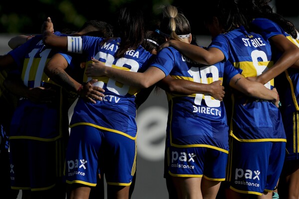 Boca Juniors' players from the women's professional team huddle before their match against River Plate in Ezeiza on the outskirts of Buenos Aires, Argentina, Sunday, March 10, 2024. A growing group of foreigners are joining the Argentinian league as it seeks to boost its recently turned professional women's soccer teams. (AP Photo/Natacha Pisarenko)