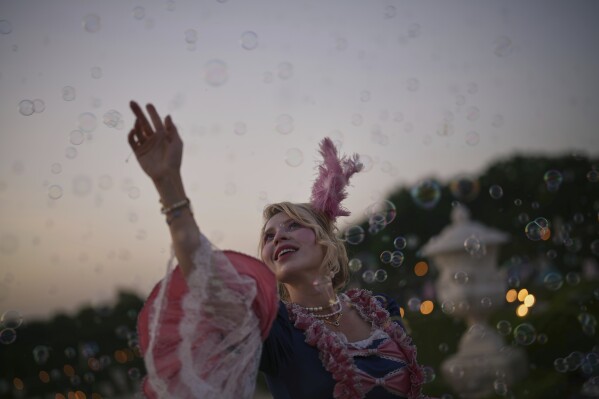 Alexandra of Ukraine poses in the gardens of the Versailles castle before the Great Masked Ball in Versailles, outside Paris, Saturday, June 21, 2025. (AP Photo/Christophe Ena)