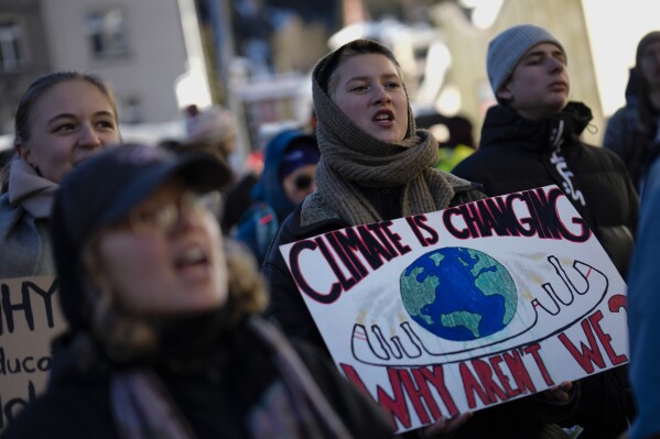 Demonstrators shout slogans during a demonstration against the World Economic Forum in Davos, Switzerland, Sunday, Jan. 14, 2024. The annual meeting of the World Economic Forum is taking place in Davos from Jan. 15 until Jan. 19, 2024.(AP Photo/Markus Schreiber)