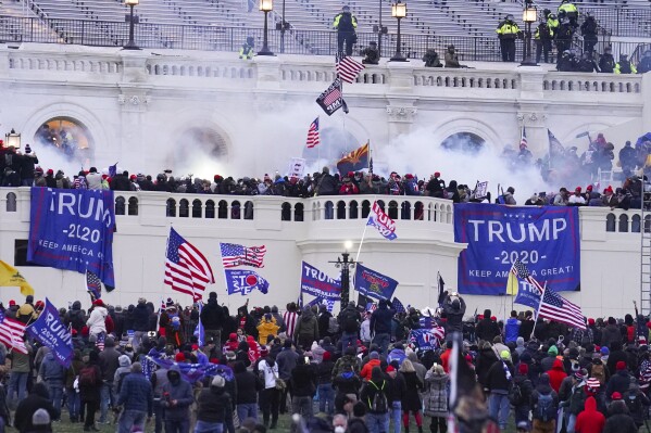 FILE - Rioters at the U.S. Capitol on Jan. 6, 2021, in Washington. Taylor James Johnatakis of Washington state, who used a megaphone to orchestrate a mob’s attack on police officers guarding the U.S. Capitol, was sentenced on Wednesday to more than seven years in prison. U.S. District Judge Royce Lamberth said videos captured Johnatakis playing a leadership role during the Jan. 6, 2021, attack. (AP Photo/John Minchillo, File)