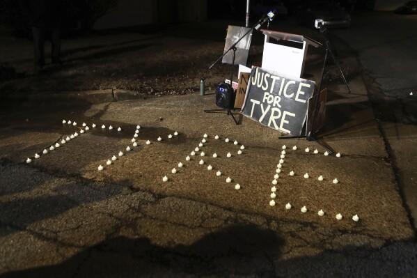 FILE - Candles spell out the name of Tyre Nichols during a candlelight vigil for Nichols on the anniversary of his death, Jan. 7, 2024, in Memphis, Tenn. A judge on Friday, March 8, 2024, indefinitely postponed the state court trial of four former Memphis officers charged with second-degree murder in the fatal beating of Tyre Nichols until after the conclusion of a federal court trial on civil rights violations. (AP Photo/Karen Pulfer Focht, file)