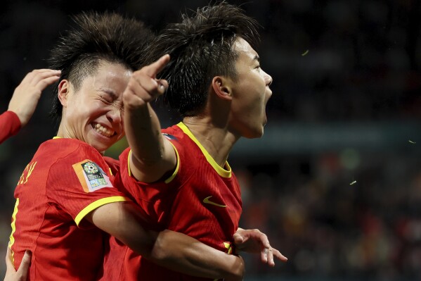 China's Wang Shuang, right, celebrates after scoring the opening goal from the penalty spot during the Women's World Cup Group D soccer match between China and Haiti in Adelaide, Australia, Friday, July 28, 2023. (AP Photo/James Elsby)