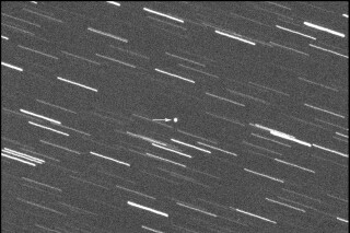 This image provided by Virtual Telescope Project out of Italy shows a single 180-second exposure asteroid that was approaching Earth, about 4 million kilometers, Thursday, Jan. 31, 2024. Astronomers say an asteroid as big as a skyscraper will pass within 1.7 million miles of Earth on Friday. There's no chance of it hitting us since it will pass seven times the distance from Earth to the moon. (Virtual Telescope Project via AP)