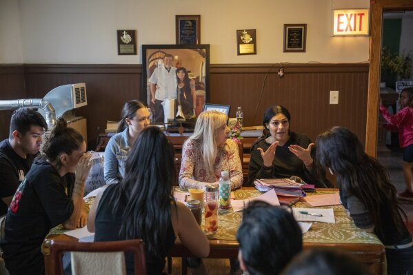 In this Wednesday, June 19, 2019 photo, Cecilia Garcia, member of La Familia Latina Unida and founder of Family Reunification not Deportation speaks during an emergency meeting plan of action on how to defend and protect undocumented communities at Lincoln Methodist Church in Chicago's Pilsen neighborhood.  Garcia's husband had been deported to Mexico after telling a suburban Chicago police officer during a 2012 traffic stop that he was living in the U.S. illegally.  (AP Photo/Amr Alfiky)