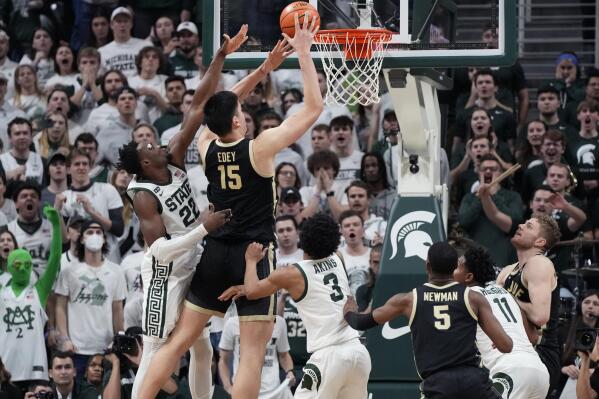 Purdue center Zach Edey (15) makes a basket with two seconds on the clock during the second half of an NCAA college basketball game against Michigan State, Monday, Jan. 16, 2023, in East Lansing, Mich. (AP Photo/Carlos Osorio)