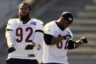 Cincinnati Bengals players B.J. Hill (92) and Quinton Spain (67) dance during warm ups during NFL football practice Wednesday, Feb. 9, 2022, in Los Angeles. The Cincinnati Bengals play the Los Angeles Rams in the Super Bowl Feb. 13. (AP Photo/Marcio Jose Sanchez)