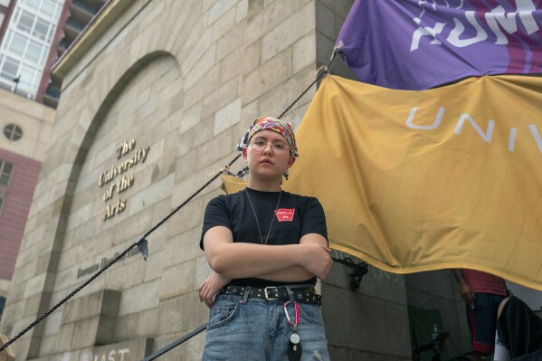Rising sophomore Cyrus Nasib, 18, stands outside Dorrance Hamilton Hall at the University of the Arts, Friday, June 14, 2024, in Philadelphia. The closure of the university has left some 1,300 other students scrambling to find somewhere to go or something to do. (AP Photo/Joe Lamberti)