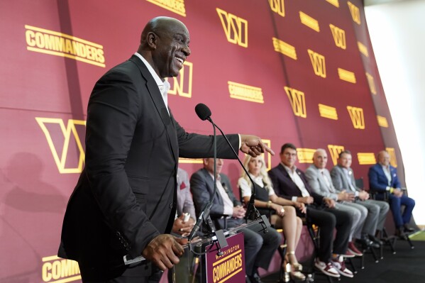 FILE - Magic Johnson, a member of the group buying the Washington Commanders, speaks at an introductory NFL football news conference at FedEx Field in Landover, Md., Friday, July 21, 2023. Magic Johnson made a surprise appearance at Washington Commanders practice Wednesday, Sept. 6, 2023, talking to players and coaches for the first time since becoming a part-owner of the NFL franchise. (AP Photo/Alex Brandon, File)