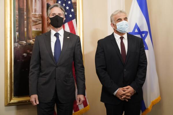 Secretary of State Antony Blinken, left, and Israeli Foreign Minister Yair Lapid pose for a family picture during their meeting in Rome, Sunday, June 27, 2021. Blinken is on a week long trip in Europe traveling to Germany, France and Italy. (AP Photo/Andrew Harnik, Pool)