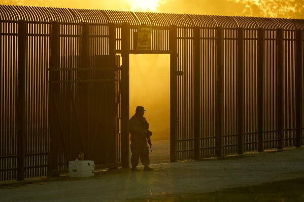 FILE - A National Guardsman stands guard at a fence that runs along the Rio Grande near the International bridge, Friday, Sept. 17, 2021, in Del Rio, Texas. As tensions continue between Texas officials and the federal government over who can enforce immigration and how, some Republican leaders are pledging their support to the lone star state. (AP Photo/Eric Gay, File)