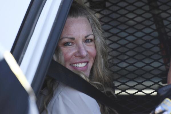Lori Vallow Daybell sits in a police car after a hearing at the Fremont County Courthouse in St. Anthony, Idaho, Tuesday, Aug. 16, 2022. Attorneys for a mom charged with conspiring to kill her children and then steal their social security benefits asked a judge on Tuesday to send the case back to a grand jury because they say the current indictment is confusing. Lori Vallow Daybell and her husband Chad Daybell have pleaded not guilty and could face the death penalty if convicted. (East Idaho News/Tony Blakeslee/East Idaho News via AP, Pool)