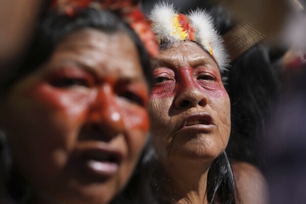 Waorani Indigenous people protest outside the Constitutional Court to protest for their right to consultation before the bidding for the exploration and exploitation of oil and gas on their territory in Quito, Ecuador, Tuesday, May 13, 2025. (AP Photo/Dolores Ochoa)