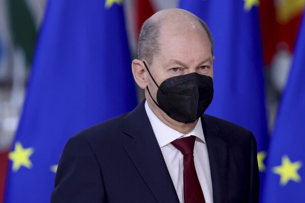 FILE - German Chancellor Olaf Scholz arrives for an EU Summit at the European Council building in Brussels, Thursday, Dec. 16, 2021. German Chancellor Olaf Scholz says he has tested positive for COVID-19. Scholz wrote on the social media platform X that he was experiencing few symptoms on Monday and "counting on a mild case.” (Kenzo Tribouillard, Pool Photo via AP, File)