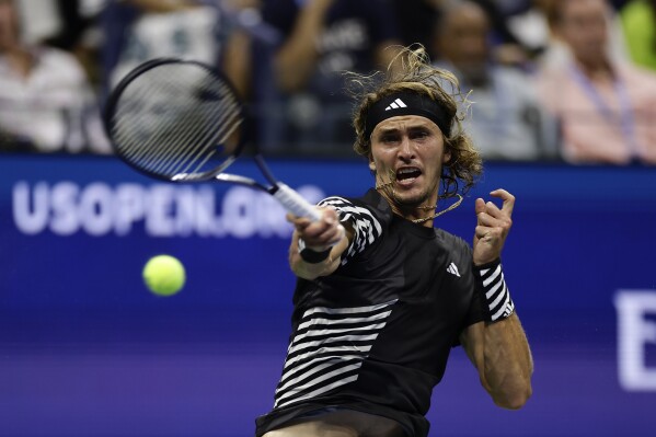 Alexander Zverev, of Germany, returns a shot to Jannik Sinner, of Italy, during the fourth round of the U.S. Open tennis championships, Monday, Sept. 4, 2023, in New York. (AP Photo/Adam Hunger)