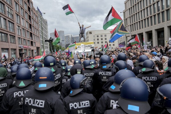 Police officers try to stop people taking part in a pro-Palestinian rally in Berlin, Saturday, May 18, 2024. (AP Photo/ Ebrahim Noroozi)