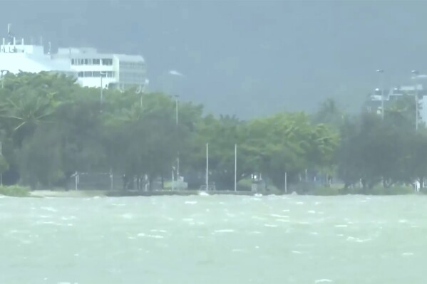 This image made from video show heavy seas in Cairns, Australia Wednesday, Dec. 13, 2023. Powerful winds began uprooting trees on the northeast Australian coast on Wednesday as Tropical Cyclone Jasper gathered strength while approaching the area. (Australian Broadcasting Corporation via AP)