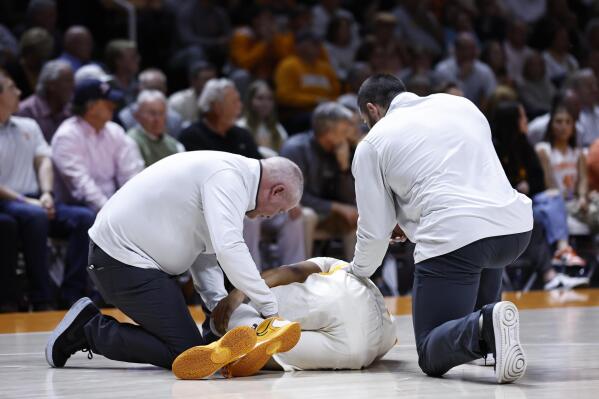 Tennessee guard Zakai Zeigler (5) lays on the floor as trainer check him after being injured during the first half of an NCAA college basketball game against Arkansas, Tuesday, Feb. 28, 2023, in Knoxville, Tenn. (AP Photo/Wade Payne)