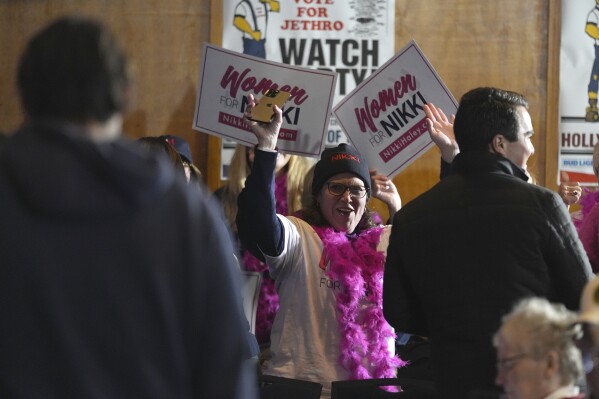 Audience members carry signs in support of Republican presidential candidate Nikki Haley in Ames, Iowa on Sunday. (AP Photo/Carolyn Kaster)