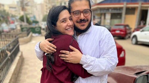 In this image provided by Egyptian Initiative for Personal Rights (EIPR), human rights activist Patrick George Zaki, who has been imprisoned for nearly two years, hugs his sister after his release outside the police station in Nile Delta city of Mansoura, Egypt, on Dec. 8, 2021. An Egyptian court has sentenced Patrick George Zaki to three years in prison over an opinion article he wrote in 2019. Egyptian Initiative for Personal Rights said the court on Tuesday, July 18, 2023 convicted Zaki of “disseminating false news” related to his article about alleged discrimination against Coptic Christians in Egypt. (EIPR via AP)