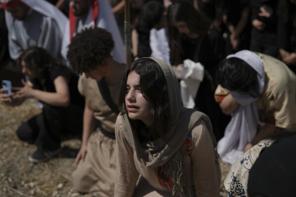 A young woman portraying a biblical figure reacts emotionally during a Good Friday reenactment of the crucifixion in Quraye, near the southern port city of Sidon, Lebanon, Friday, April 18, 2025. (AP Photo/Hassan Ammar)