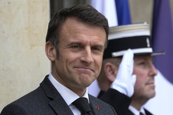 FILE - French President Emmanuel Macron waits on the steps of the Elysee Palace, Monday, March 11, 2024 in Paris. On Friday, May 10, 2024,  reported on stories circulating online incorrectly claiming that France sent troops to fight in the Russia-Ukraine war. (AP Photo/Michel Euler, File)