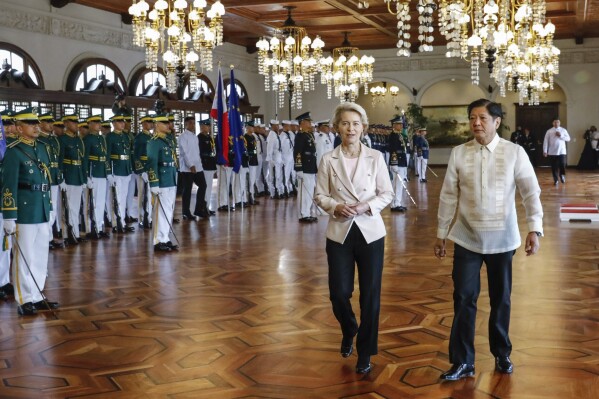 Philippine President Ferdinand Marcos Jr., right, walks with European Commission President Ursula von der Leyen, left, during the arrival ceremony at the Malacanang presidential palace in Manila, Philippines, Monday, July 31, 2023. (Rolex dela Pena/Pool Photo via AP)
